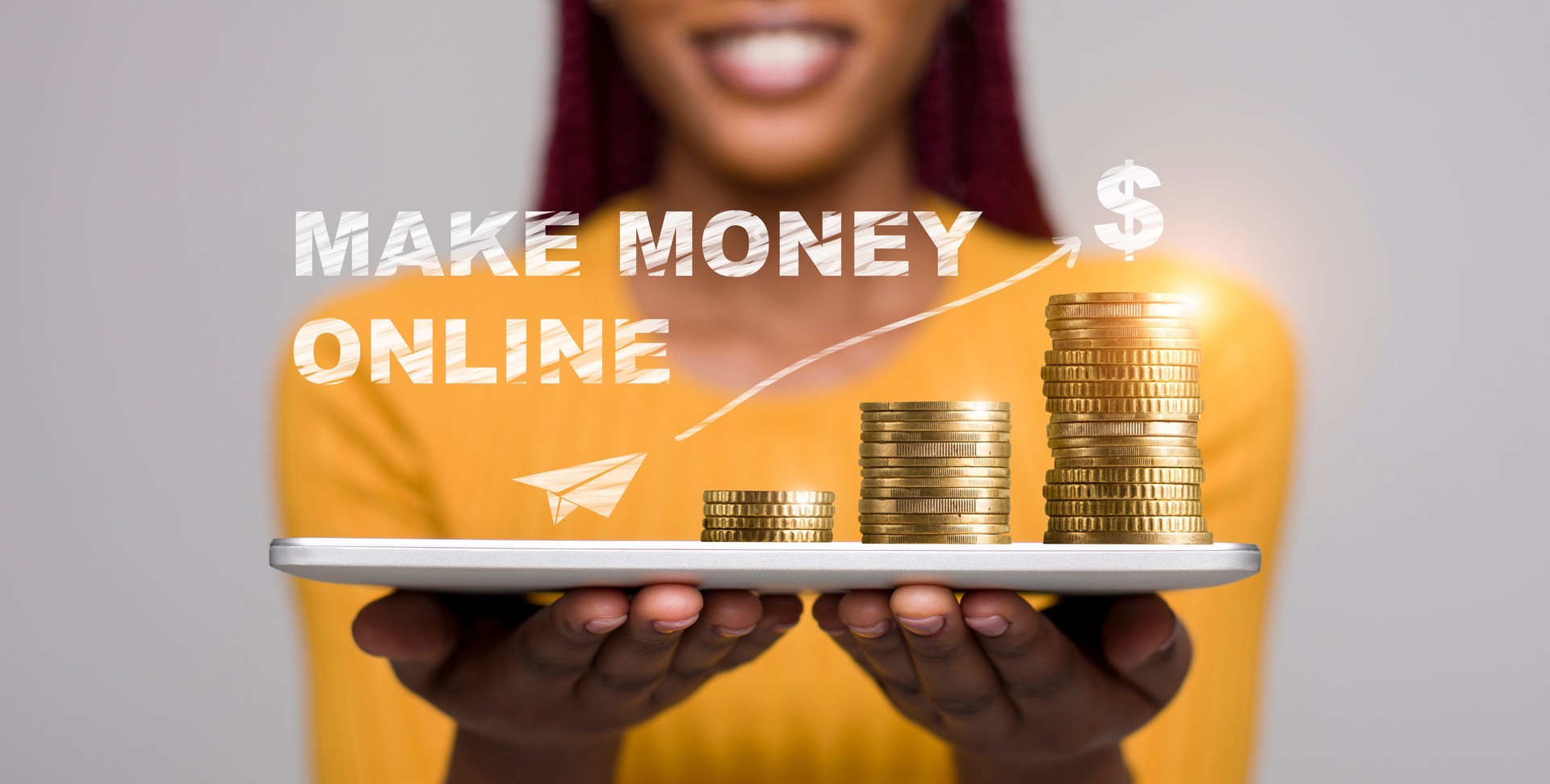 African woman holding in hands tablet with coins on it